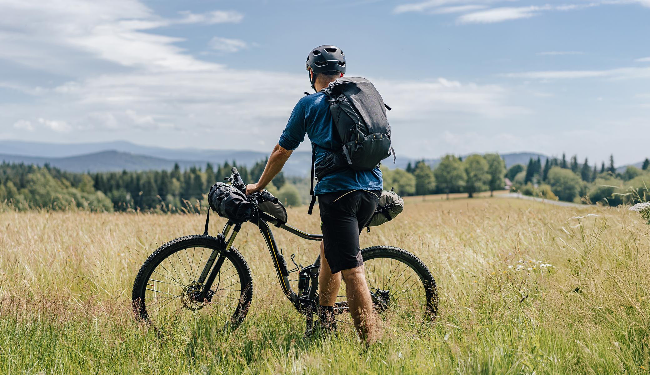 Trekking biker in the fields